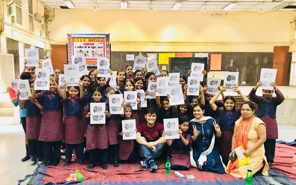 A group of children with banners in their hands.