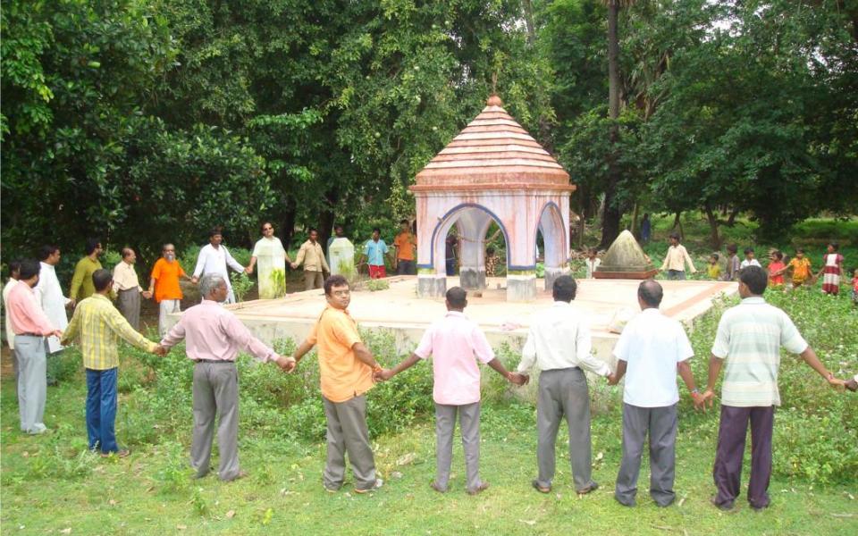 people holding hands in a circle 