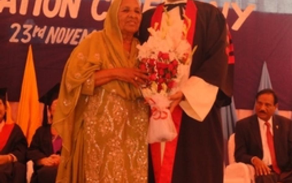 James father holding his award with his wife 