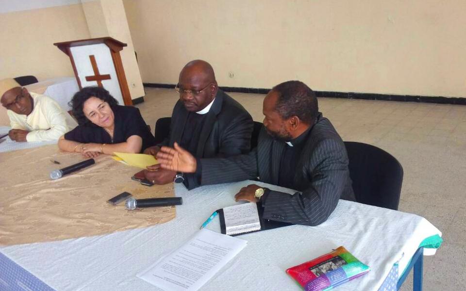 Image of people sitting at a table, talking