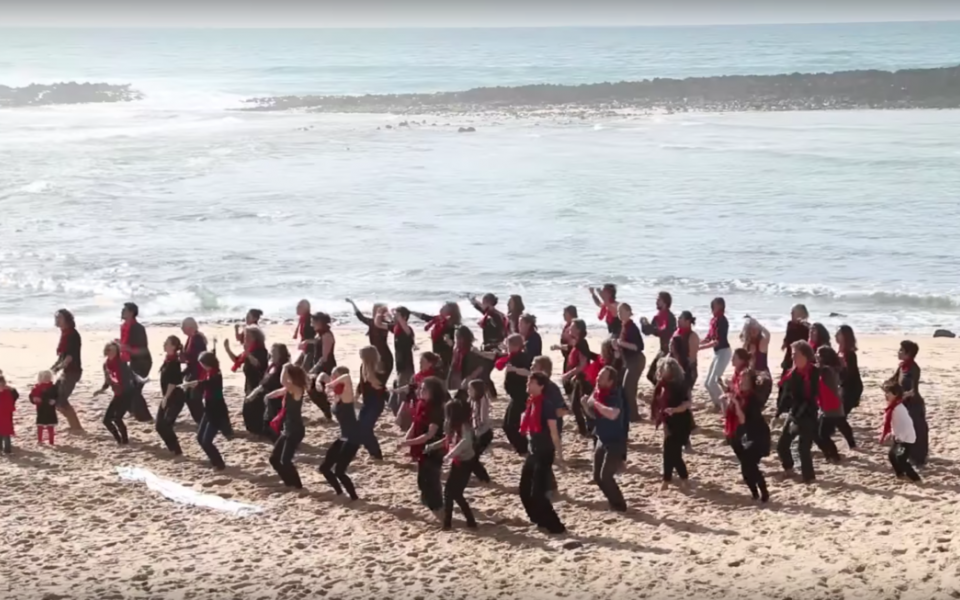 people dancing together on the beach