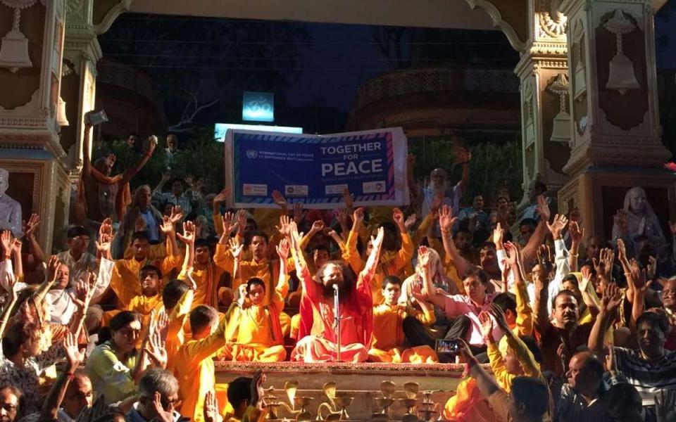 Photo of people praying with their hands raised