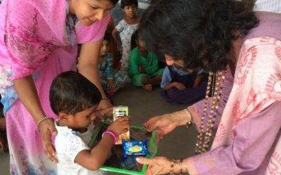 Satya plays with school children. 