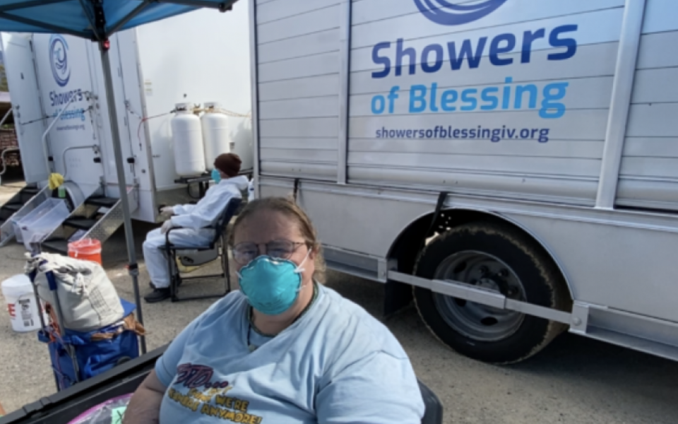 Photo: woman on front of shower of blessing banner