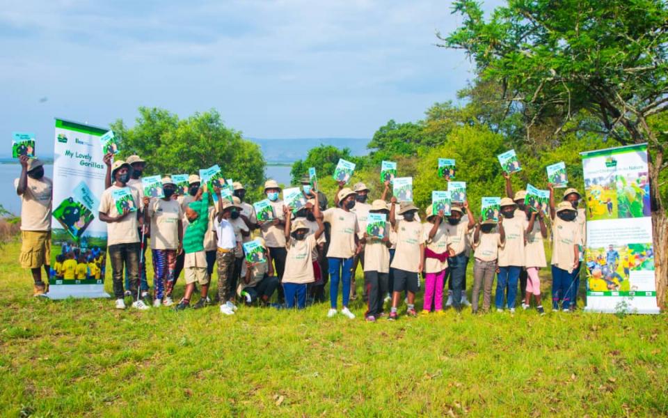 Group Photo: Participants of the Eco Arts Camp stand for a group photo, each child with a book in their hand