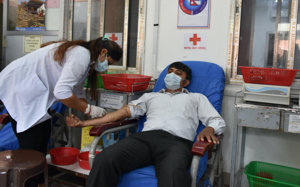 Special guest Bhattarai inaugurates the Blood Donation Program by donating blood.